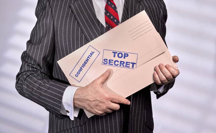 Businessman holding a top secret confidential file in his hands.